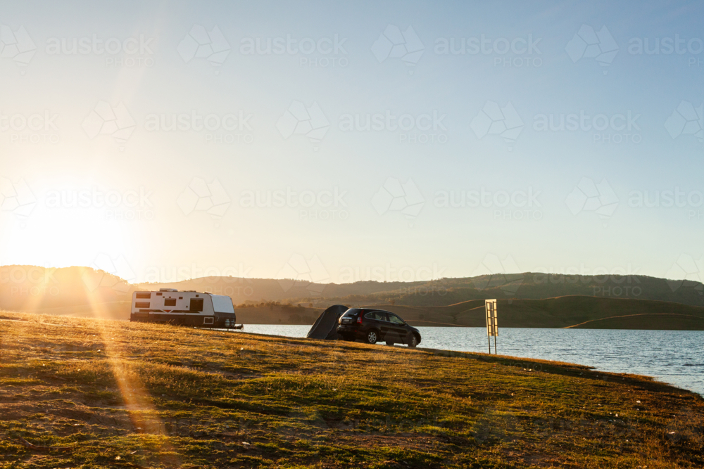 Car caravan and tent along the shoreline of inland lake in Australia - Australian Stock Image