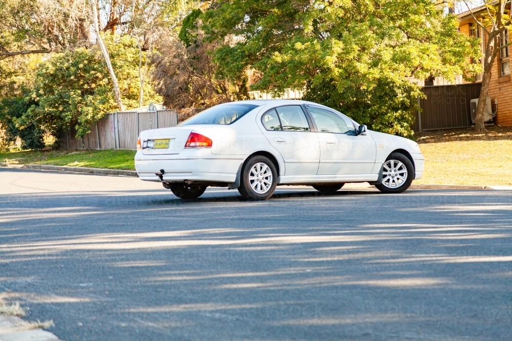 Car doing u-turn on road - Australian Stock Image