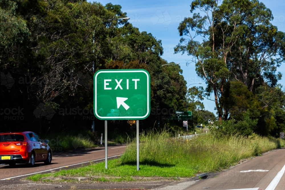 Car exiting highway with exit sign - Australian Stock Image