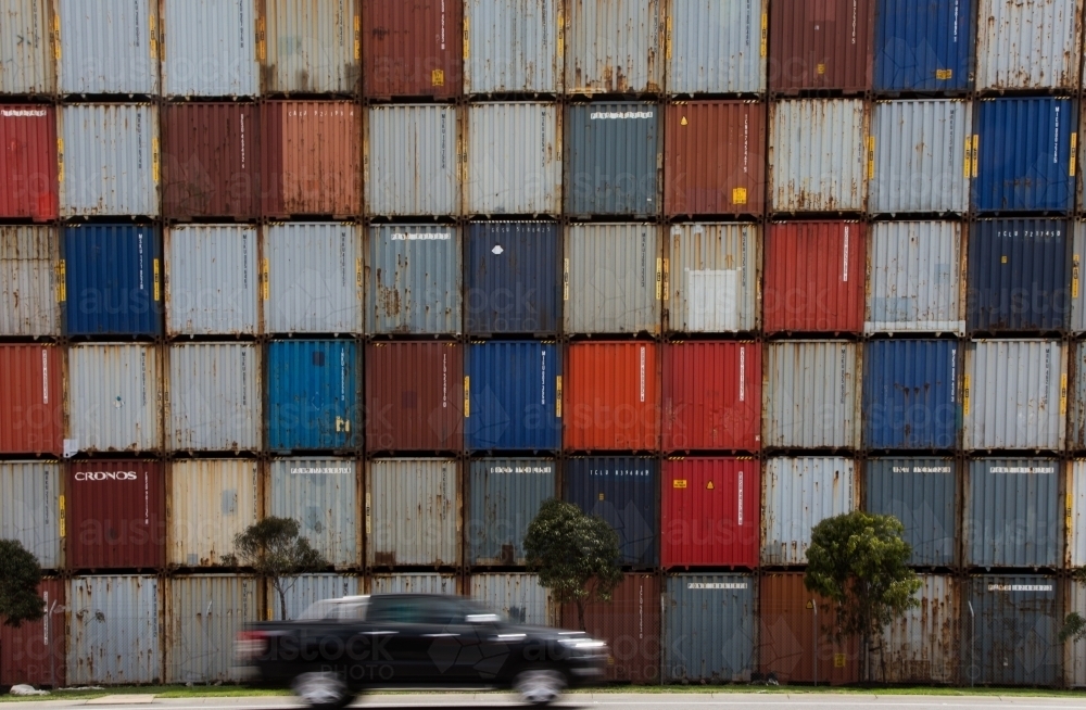 Image of Car in front of colourful shipping containers - Austockphoto