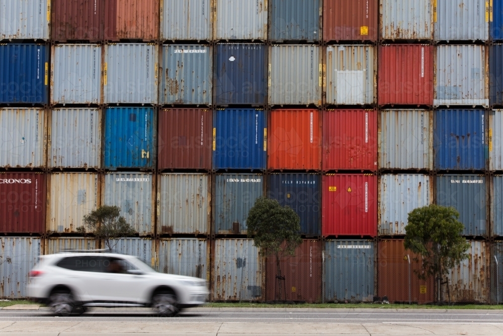 Car in front of colourful shipping containers - Australian Stock Image