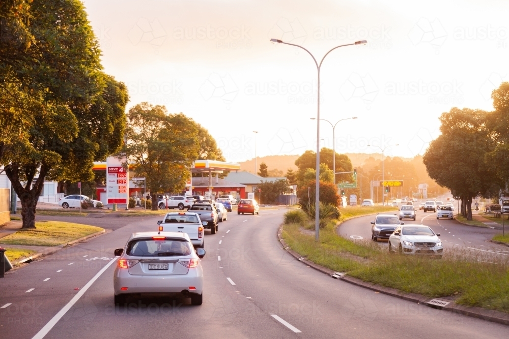 Car in heavy traffic with break lights on at sunset on multi lane road - Australian Stock Image