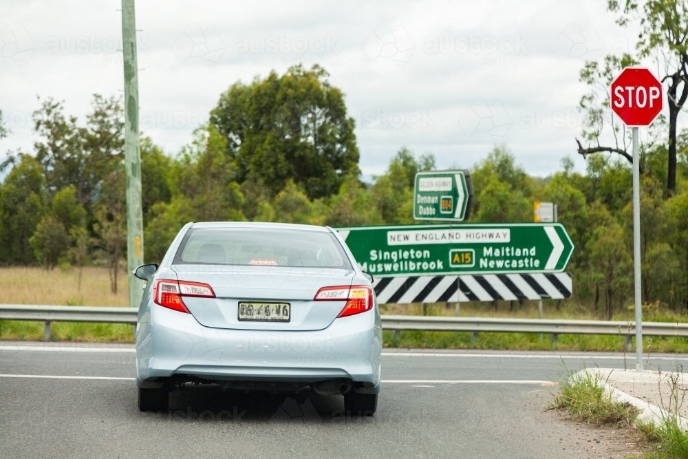Car indicating to turn right at intersection, headed towards Newcastle on the highway - Australian Stock Image