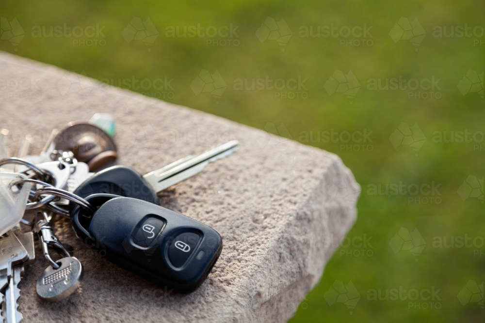 Car keys and house key-ring on post beside house door - Australian Stock Image