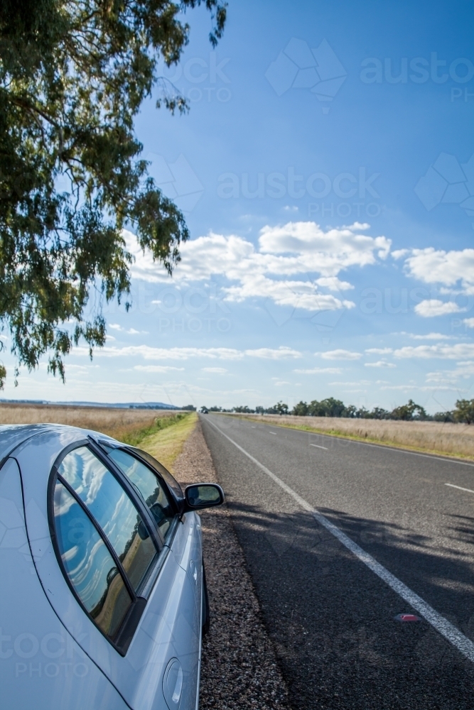Car on the roadside of a remote country road - Australian Stock Image
