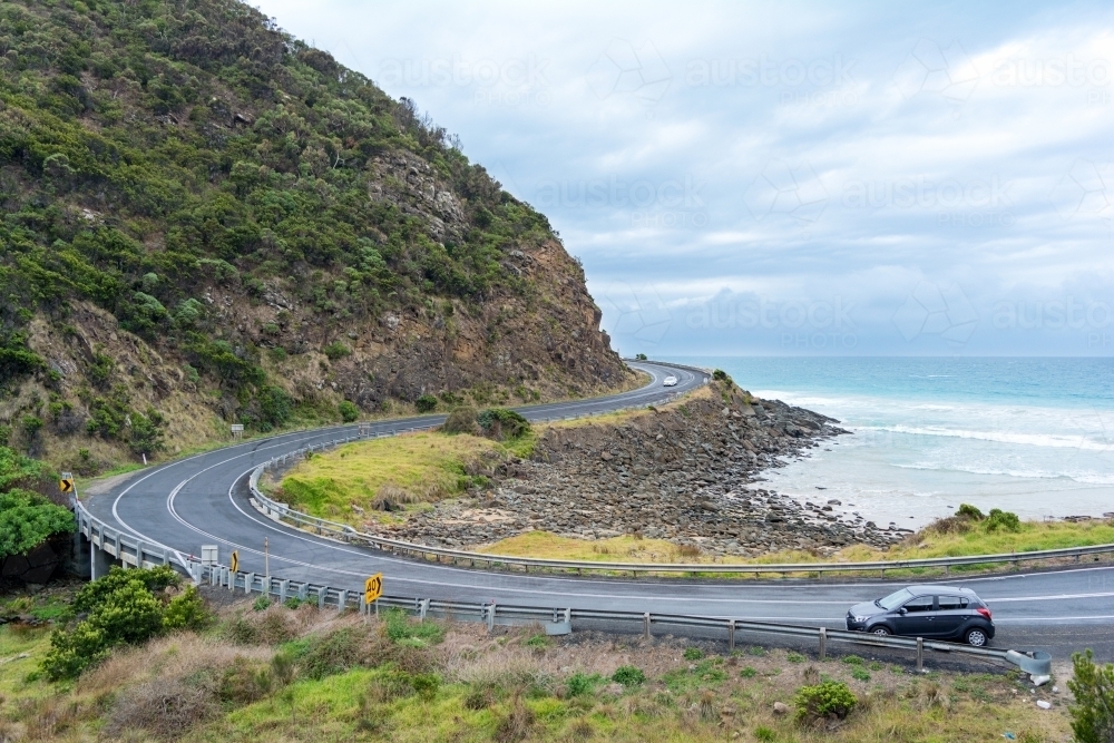 Car parked alongside the road against an ocean backdrop - Australian Stock Image
