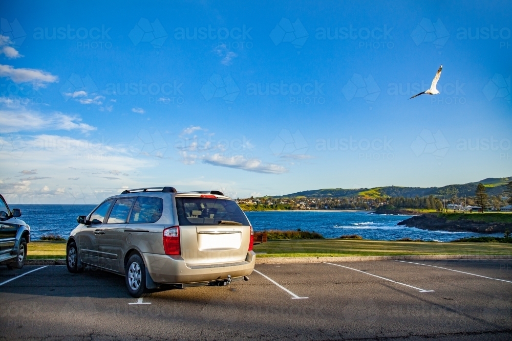 Car parked badly over two parks in coastal car park - Australian Stock Image