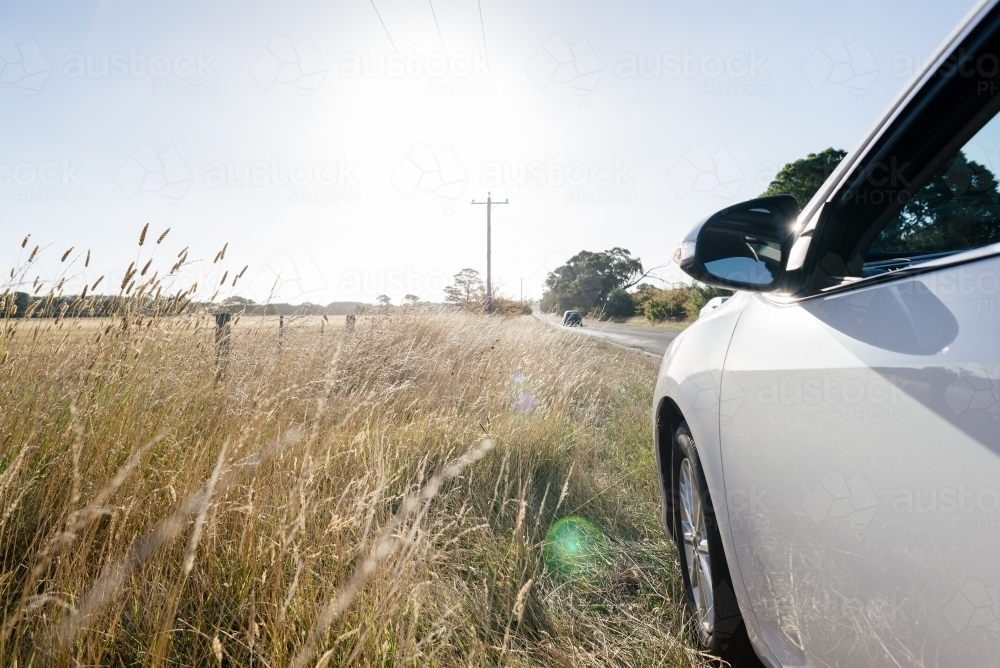 Car parked side of road on an afternoon weekend roadtrip in regional country Victoria, Australia - Australian Stock Image