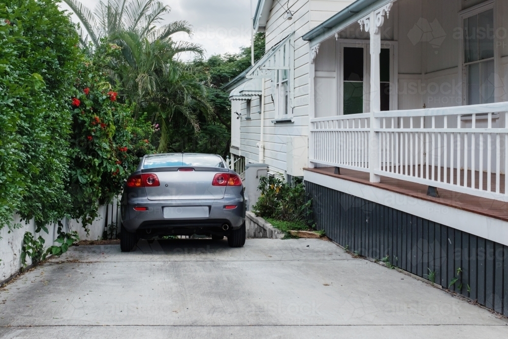 Image of car parked in house driveway Austockphoto