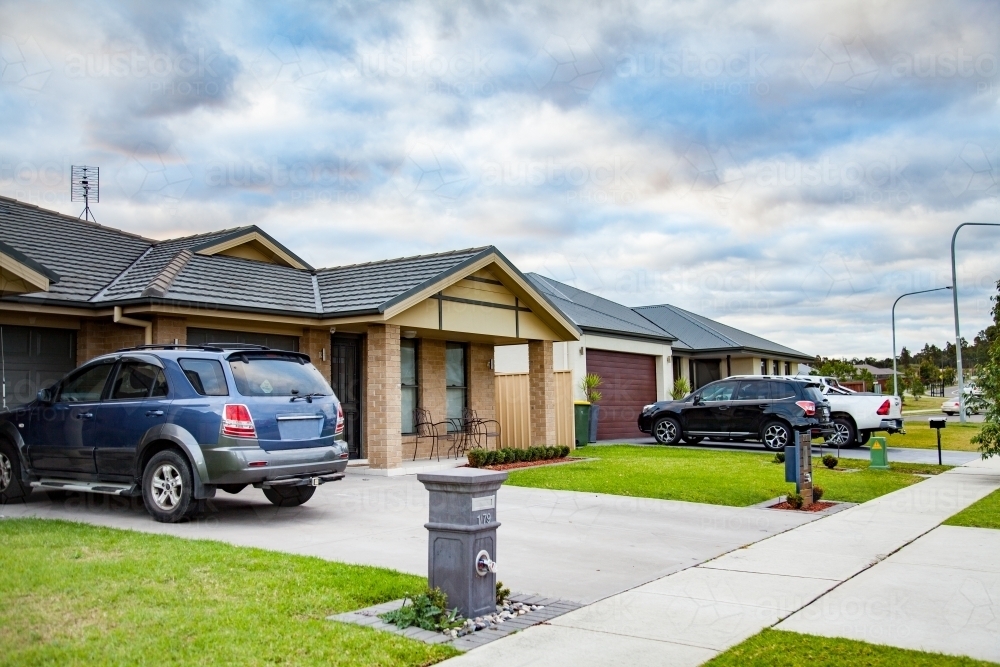 Image of Car parked in suburban residential house driveway