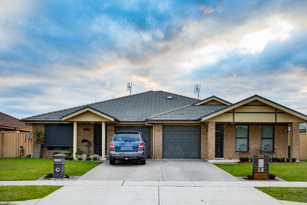 Car parked in suburban residential house driveway - Australian Stock Image