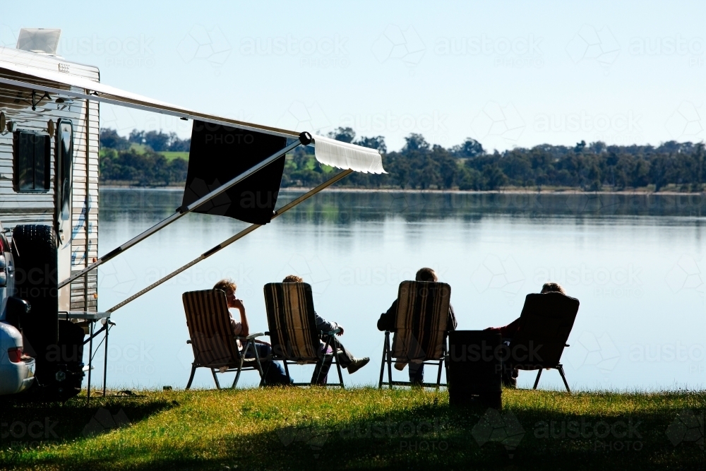 caravaners relax beside lake - Australian Stock Image