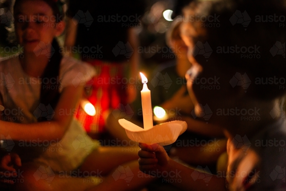 carols by candlelight with family and friends around - Australian Stock Image