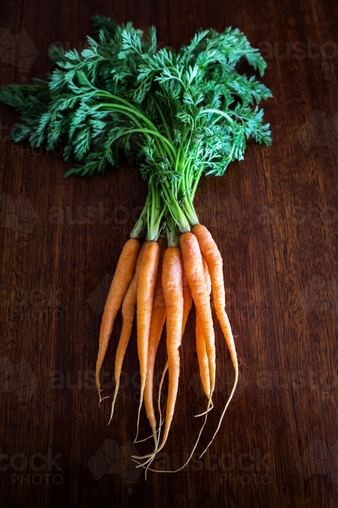 Carrots on a wooden kitchen bench - Australian Stock Image