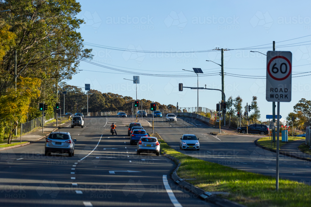 Motorcycle Intersection Image of cars and motorcyclist at intersection with traffic light ...