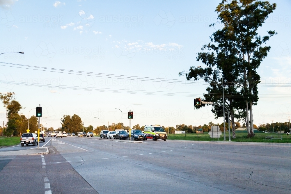 Cars crossing intersection with traffic lights - Australian Stock Image