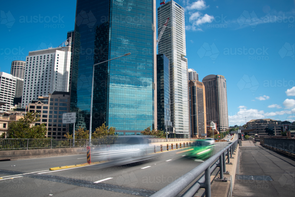Cars driving on Cahill Expressway with city buildings and skyline in the background - Australian Stock Image