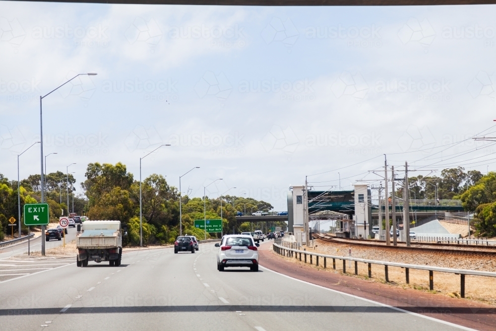 Cars driving on road with three lanes - Australian Stock Image
