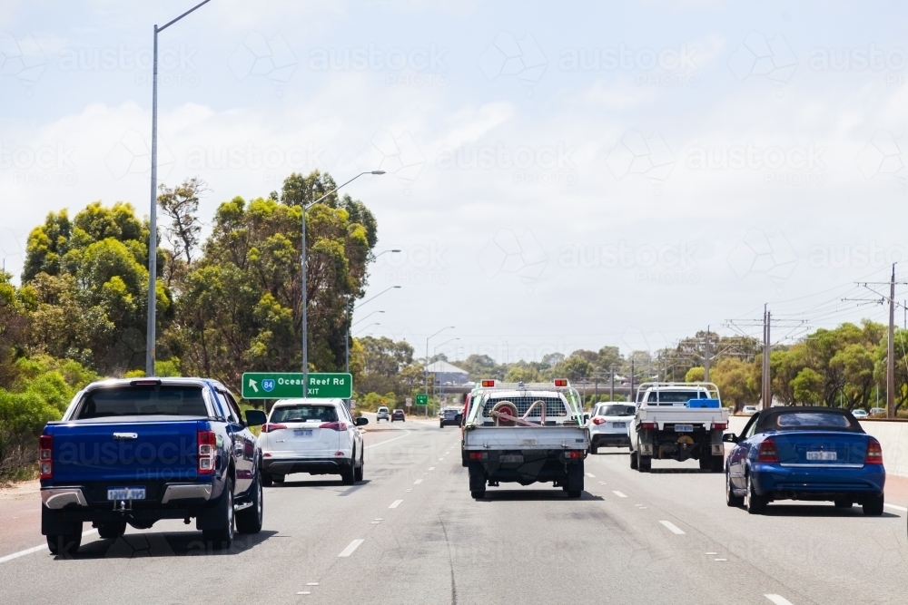 Cars driving on road with three lanes - Australian Stock Image