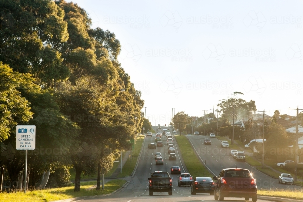 Cars in peak hour traffic driving on road in the afternoon - Australian Stock Image