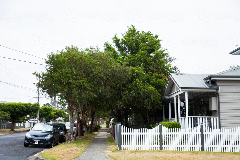 Cars parked along street and houses with footpath - Australian Stock Image