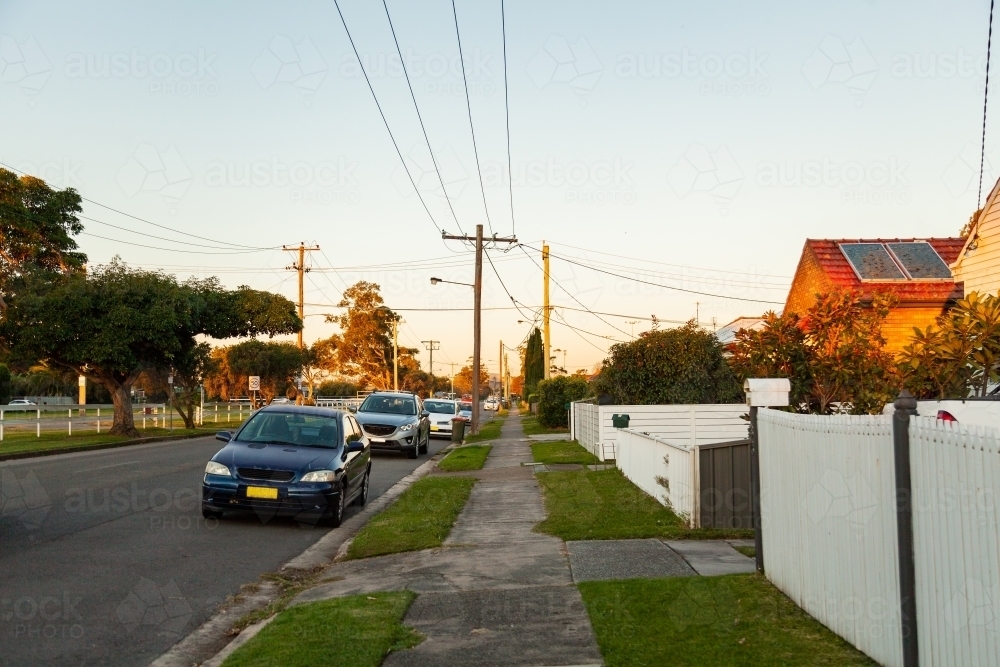 Cars parked along the road beside houses - Australian Stock Image
