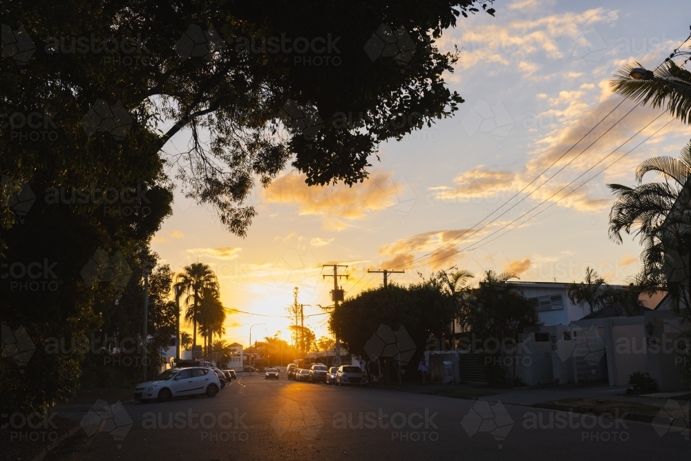 Image of Cars parked in residential street at sunset - Austockphoto