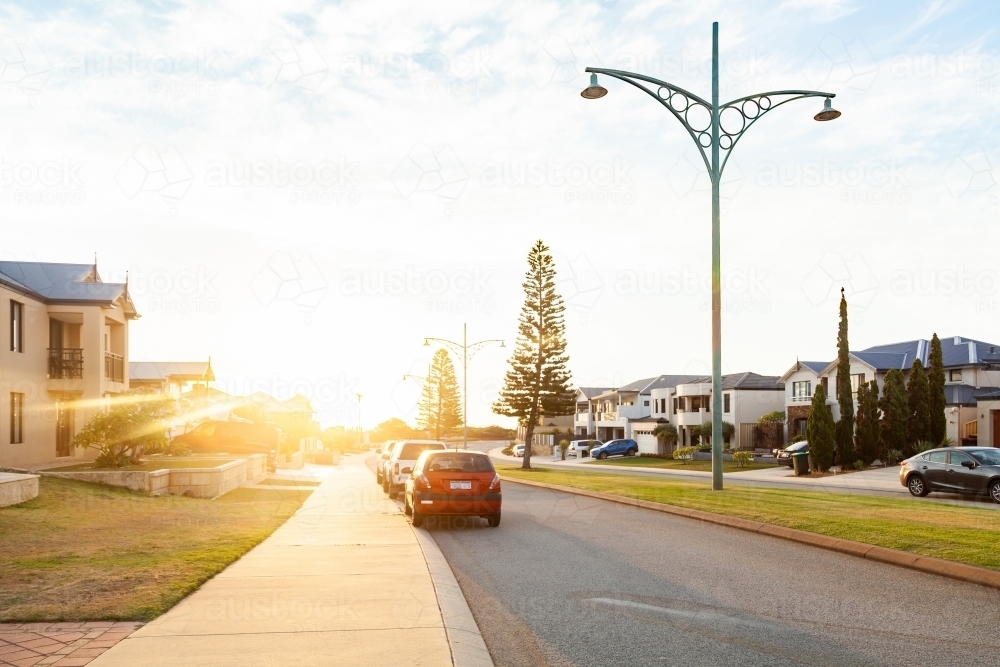 Cars parked on the street at sunset - coastal community - Australian Stock Image