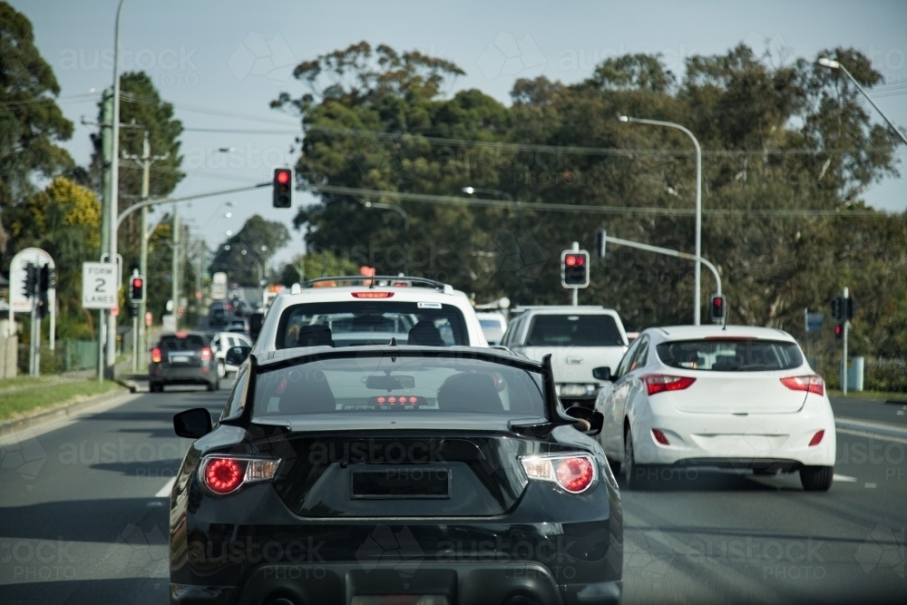Cars stopped on the road at red traffic lights - Australian Stock Image