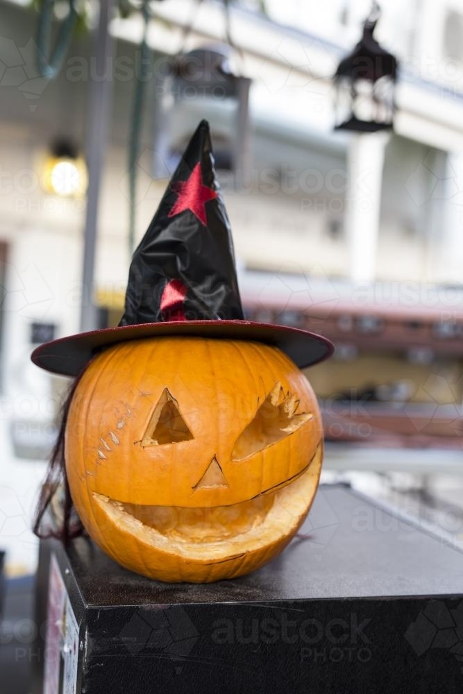 Carved Halloween Pumpkin with black witches hat - Australian Stock Image
