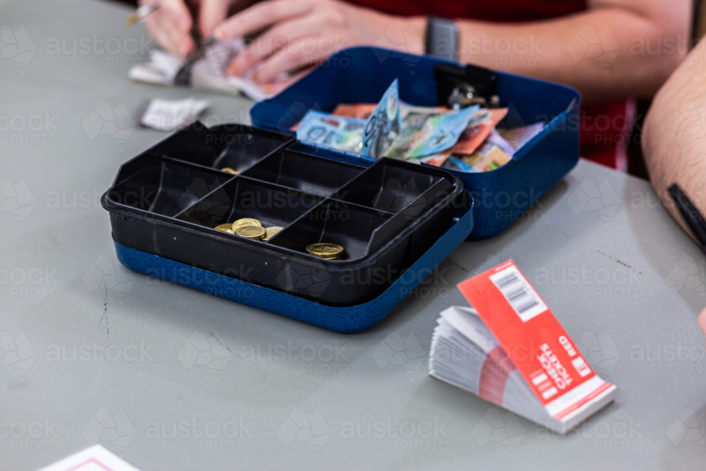 Book Raffle Box Image of Cash box with raffle ticket book on table and person selling ...