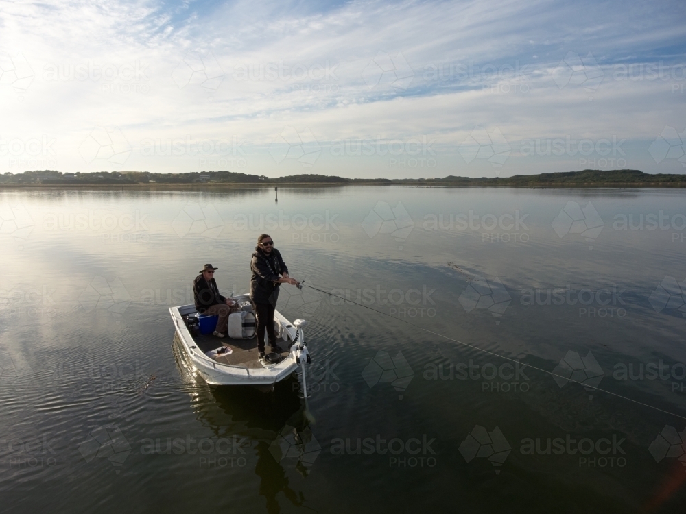 Casting a Lure from a Boat While Fishing - Australian Stock Image