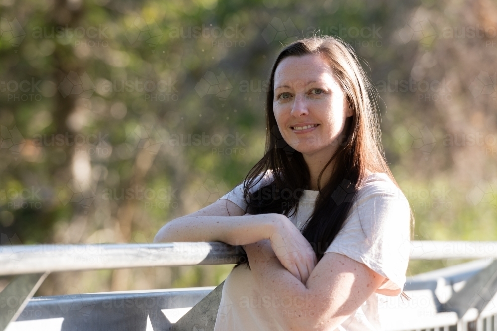 Casual, environmental portrait of a  young woman with blurred background - Australian Stock Image
