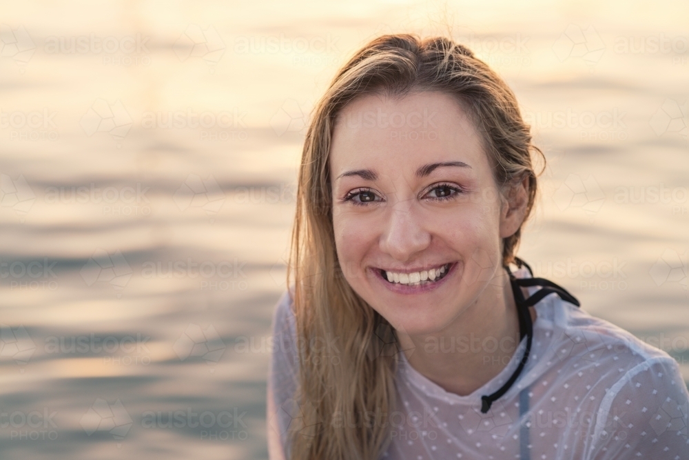 casual natural portrait of woman by ocean - Australian Stock Image