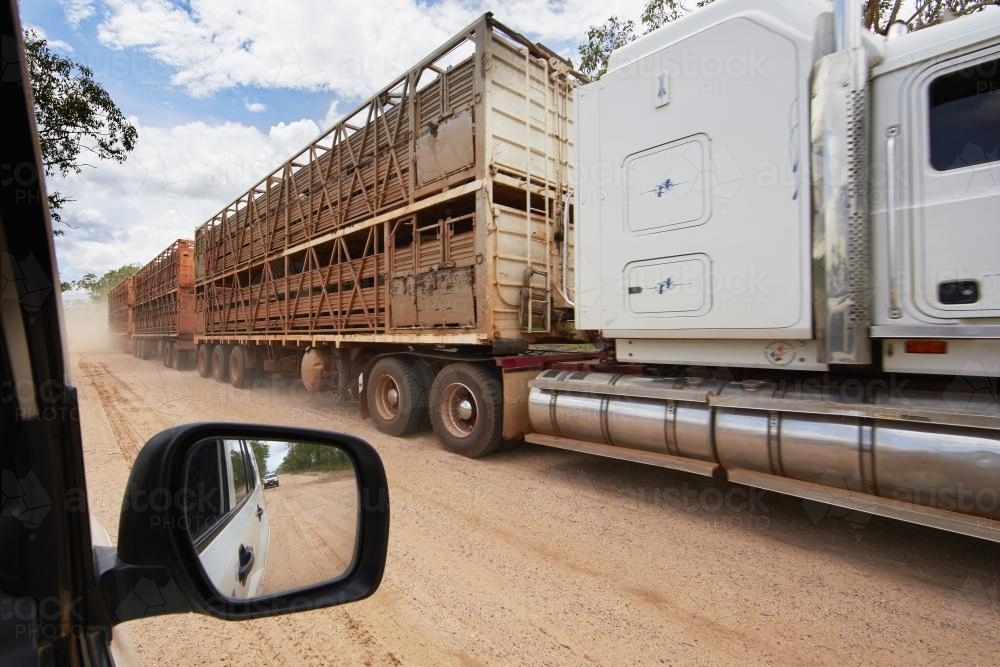 Cattle transport truck passes 4wd on dirt road. - Australian Stock Image