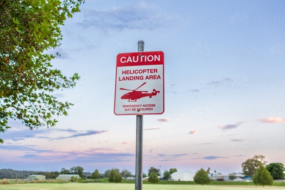 Caution Helicopter landing area warning sign near sports ground - Australian Stock Image
