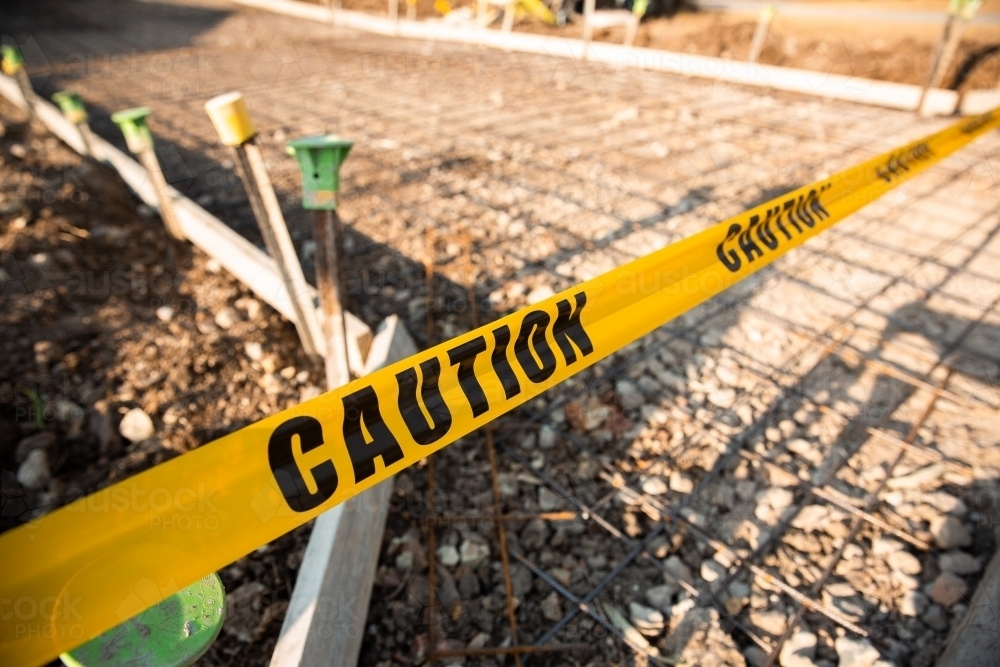 caution tape at a new driveway pour - Australian Stock Image