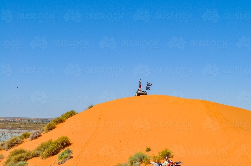celebrating on top of a sand dune - Australian Stock Image