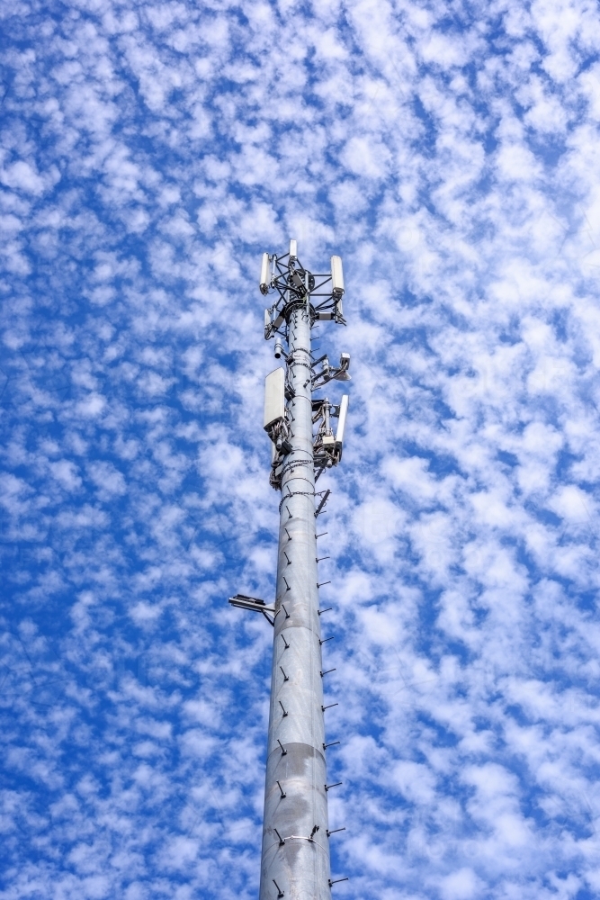 Cell phone telecommunication tower against blue sky and amazing clouds background, Melbourne - Australian Stock Image