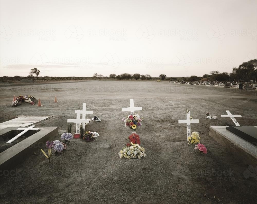 Cemetery with wooden crosses and flowers - Australian Stock Image