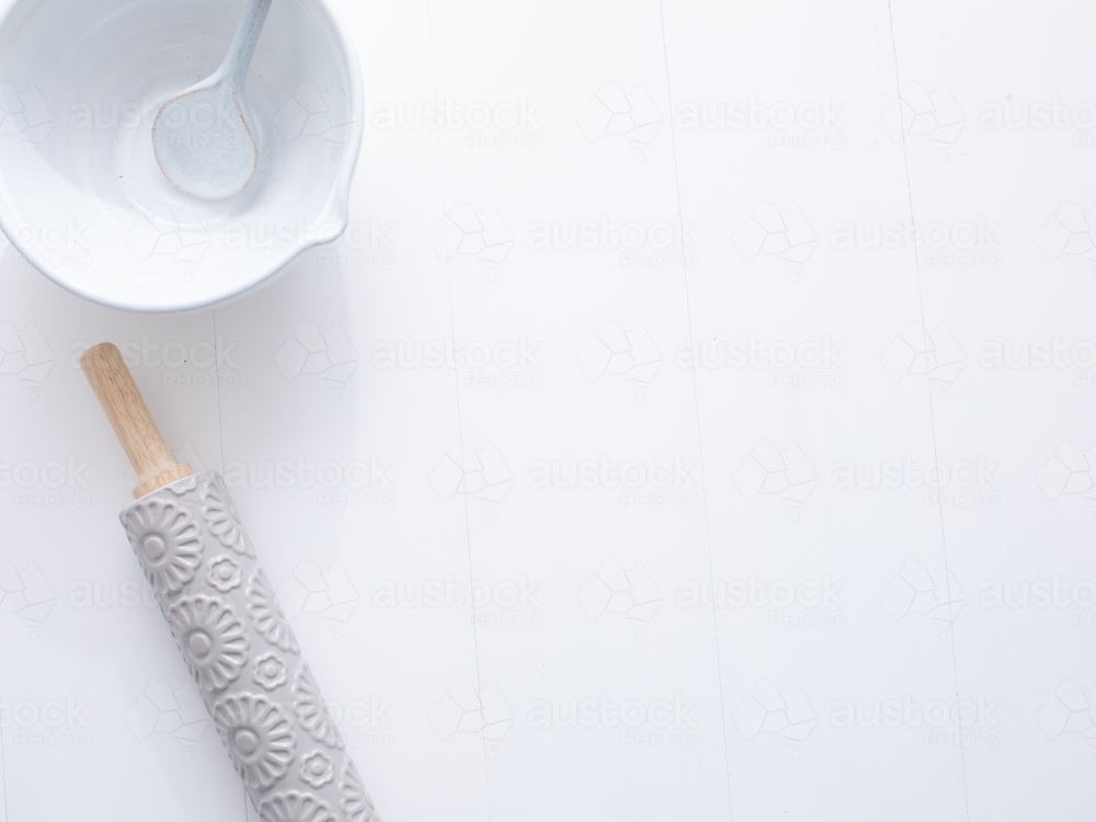 Ceramic mixing bowl with spoon and rolling pin - Australian Stock Image