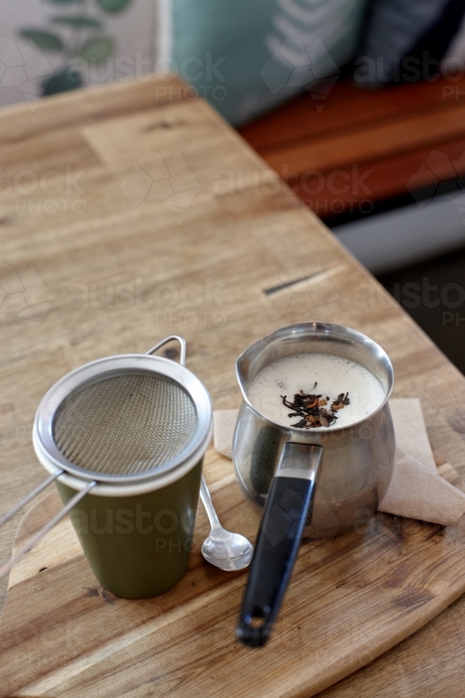 Chai latte prepared on table in cafe - Australian Stock Image