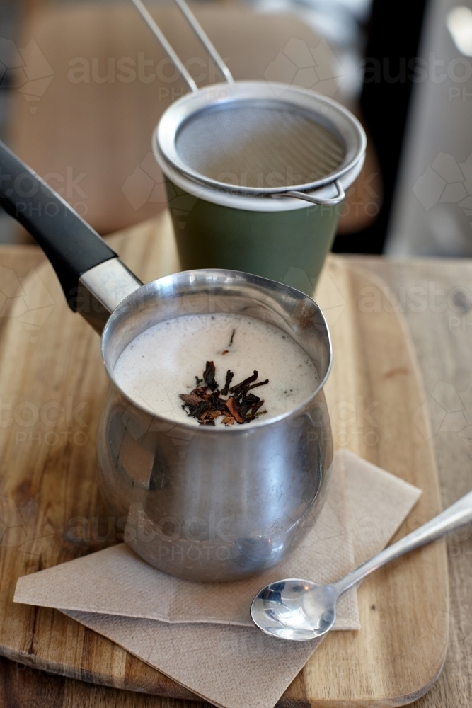 Chai latte prepared on table in cafe - Australian Stock Image