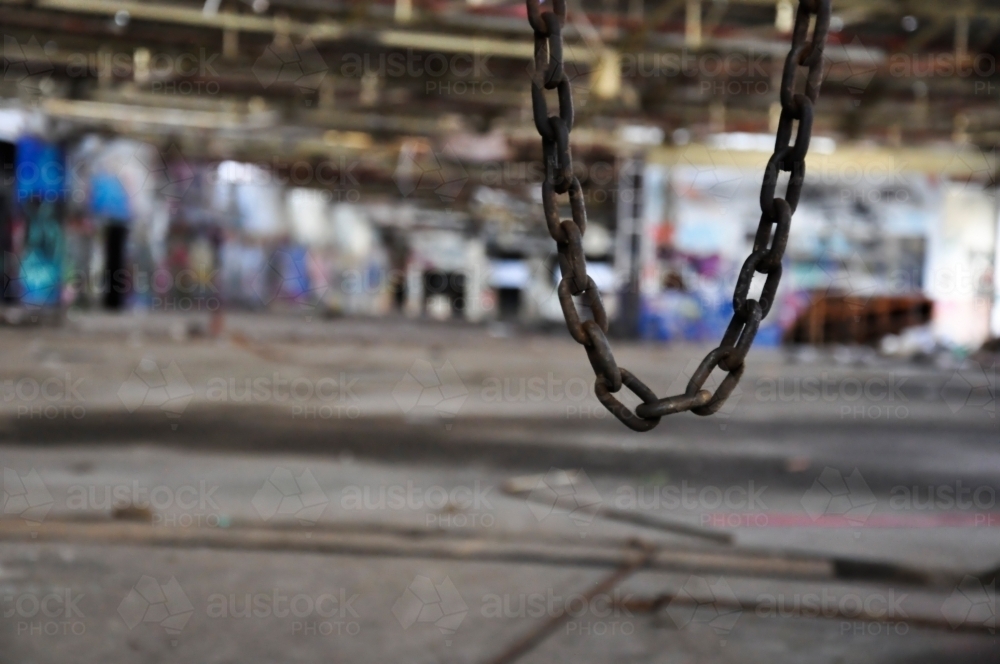 Chain in abandoned warehouse - Australian Stock Image