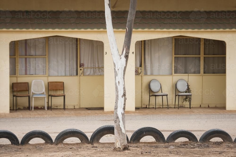 Chairs outside a pale yellow motel on the Nullarbor - Australian Stock Image