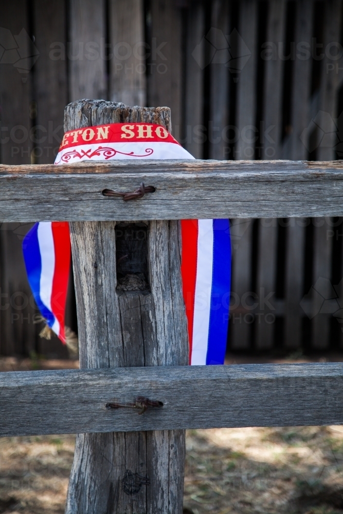 Champion show ribbon around wooden post at showground - Australian Stock Image