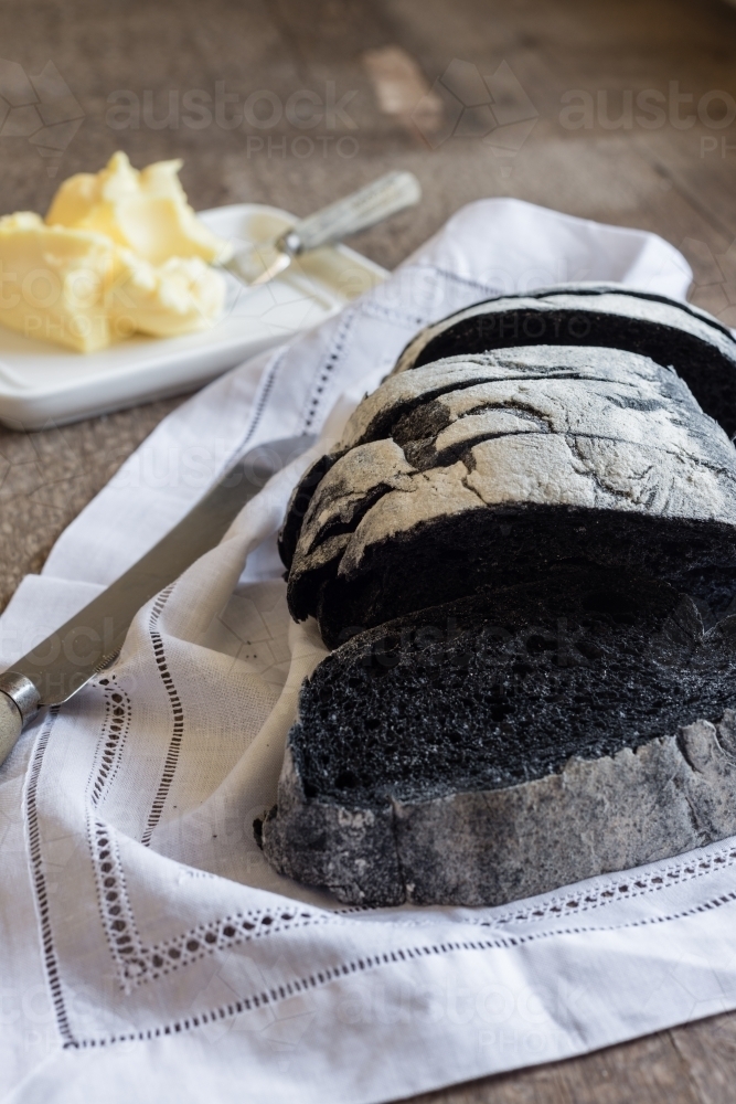 charcoal bread with butter - Australian Stock Image