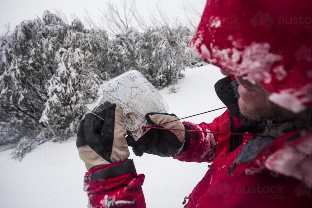 Checking the map whilst winter hiking - Australian Stock Image