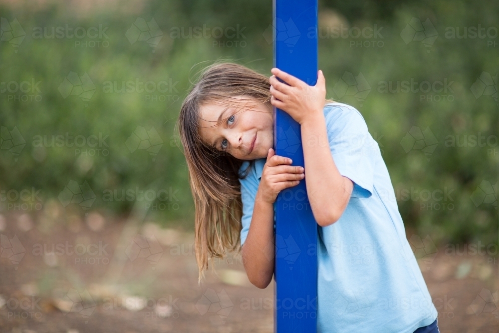 Cheeky school kid hanging onto pole - Australian Stock Image