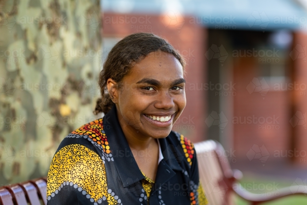 cheerful smiling teenaged girl head and shoulders with - Australian Stock Image